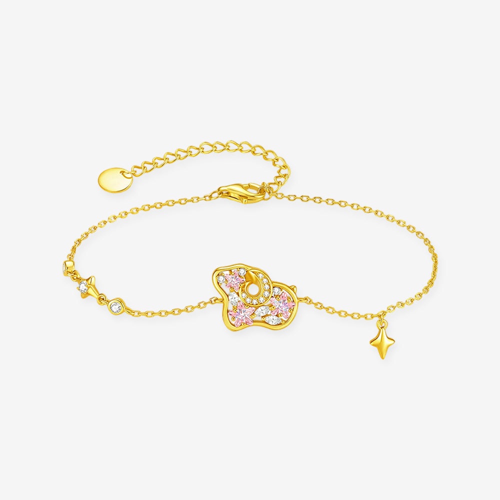 Gold-tone pink cubic zirconia sheep bracelet with star charm, lobster clasp and extender on white