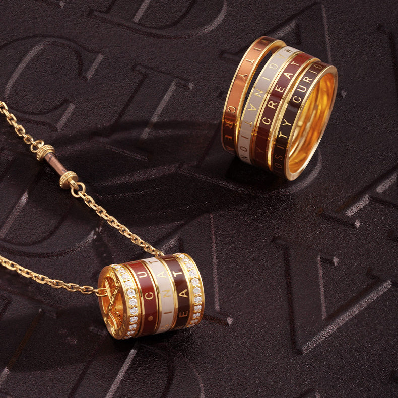 Close-up of 24K gold barrel pendant disassembled, showing engraved inner surface and precision thread mechanism