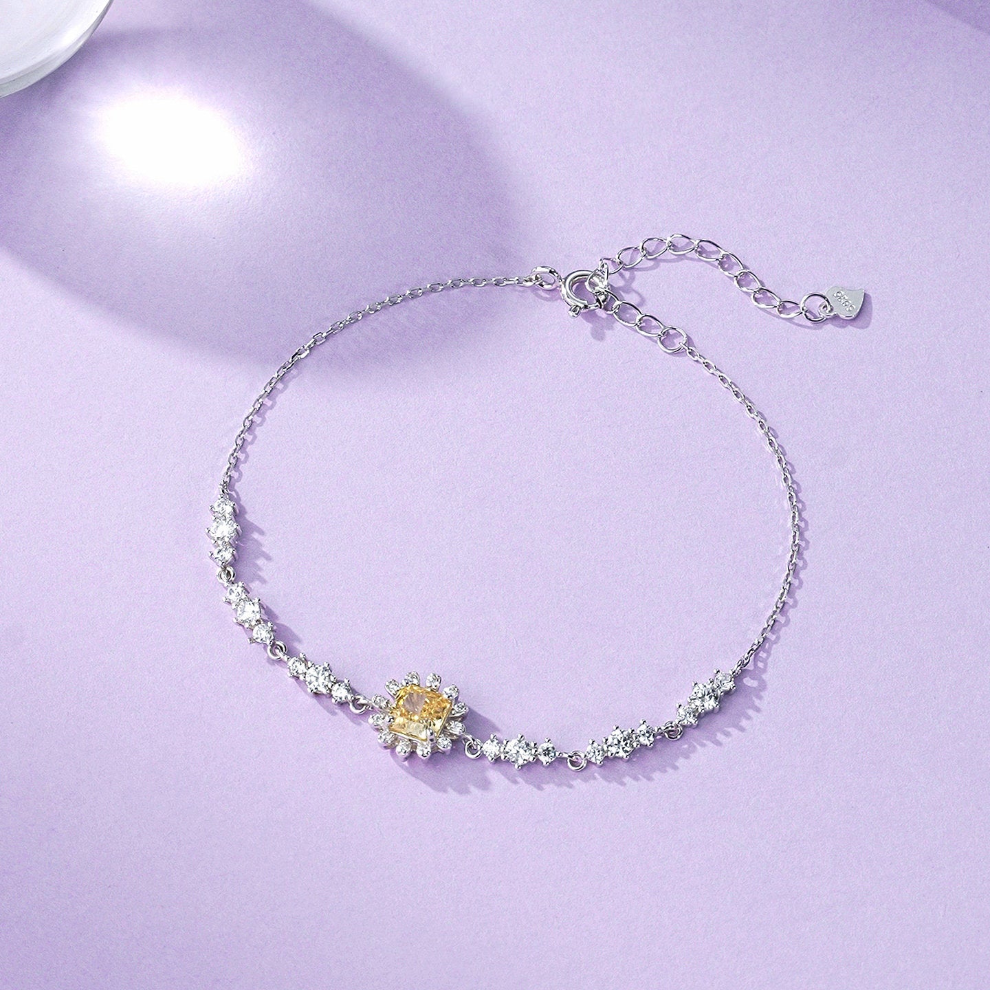 Close-up of little sun charm with sparkling cubic zirconia on 925 sterling silver bracelet – ChowTaiSeng