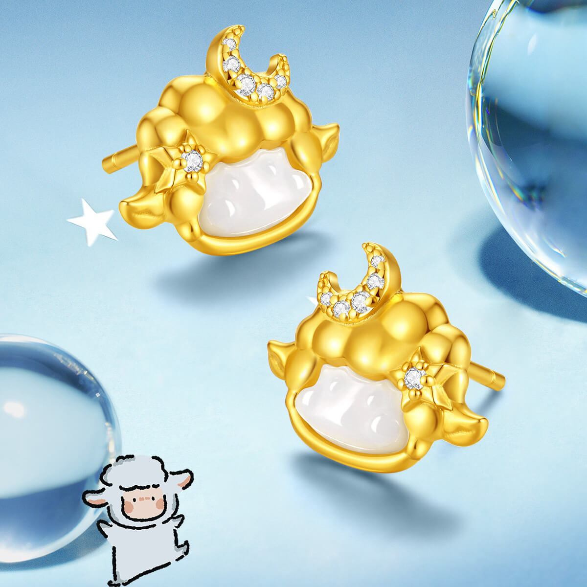 Gold-plated silver sheep stud earrings with white chalcedony and cubic zirconia moons on a blue background