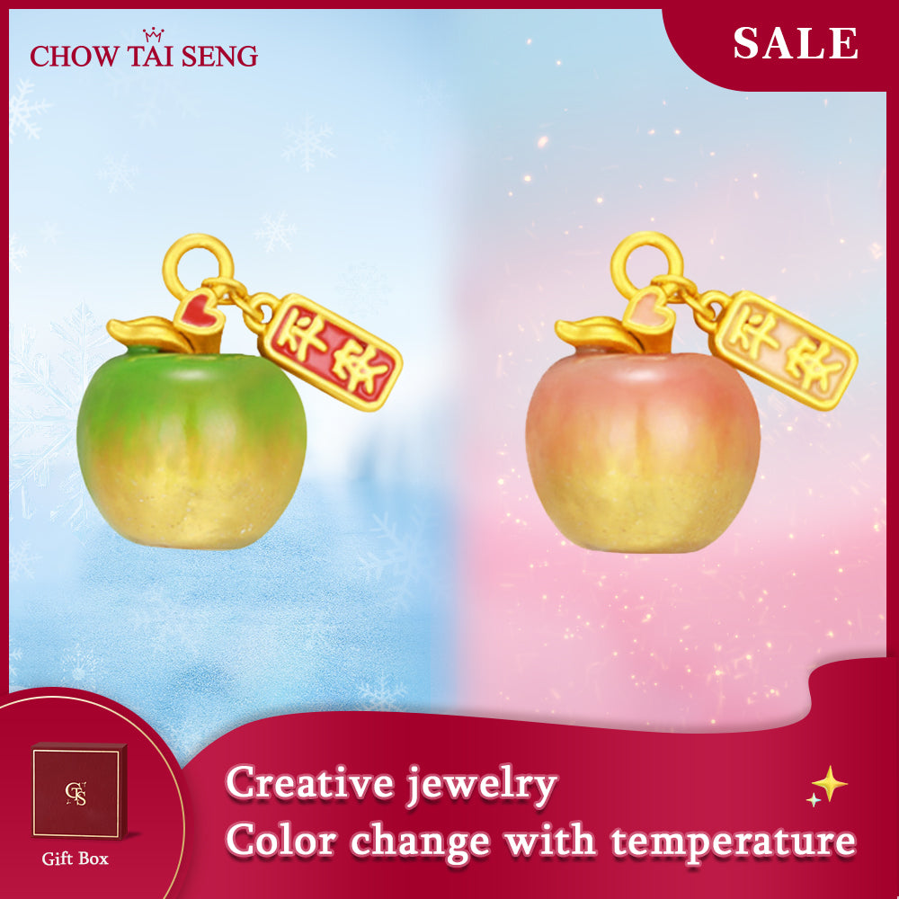ChowTaiSeng 24K gold enamel apple charm — cool green and warm pink colour change comparison with good luck tag, gradient background