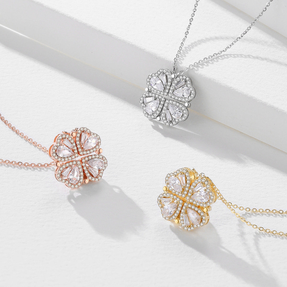 Rose-gold-tone, silver-color and gold-tone cubic zirconia necklaces in the closed four-leaf clover shape