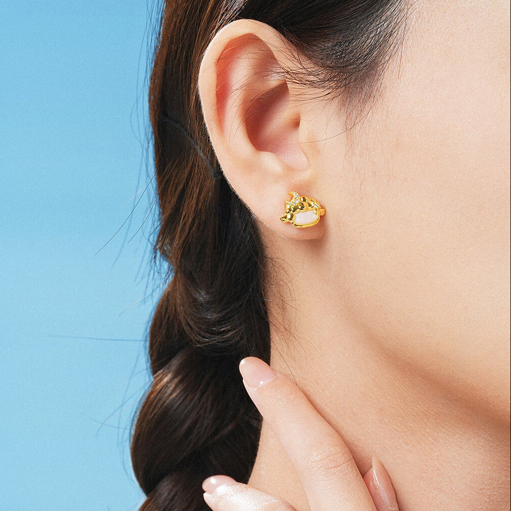 Close-up of a model wearing a gold-plated silver chalcedony sheep stud earring with a cubic zirconia moon