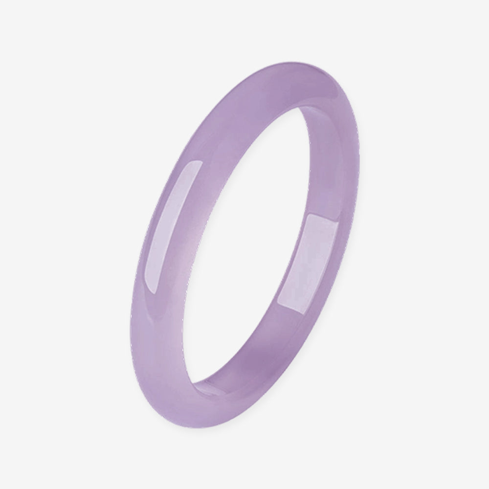 Elegant violet chalcedony bangle on white background, showing smooth polished surface and soft purple hue