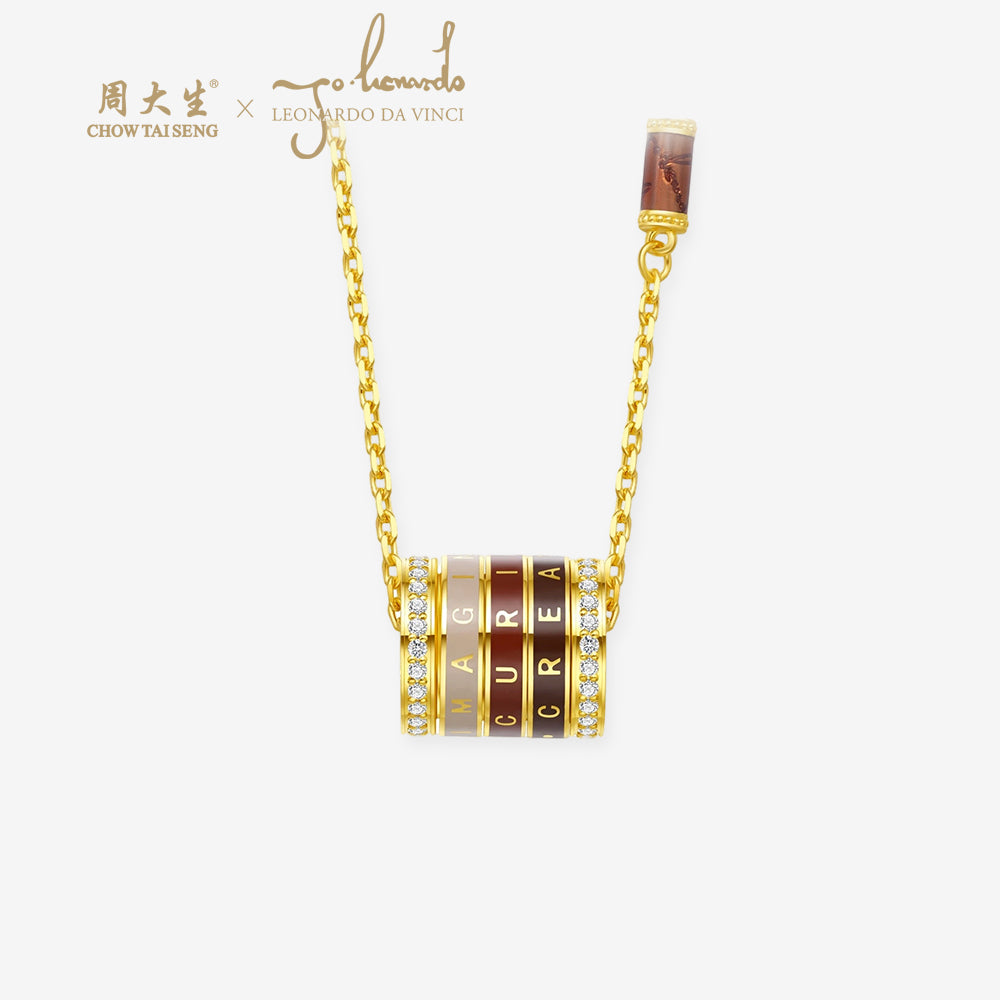 ChowTaiSeng x Leonardo da Vinci 24K gold diamond convertible barrel necklace on white background, showing modular ring pendant with red and beige enamel and diamond accents