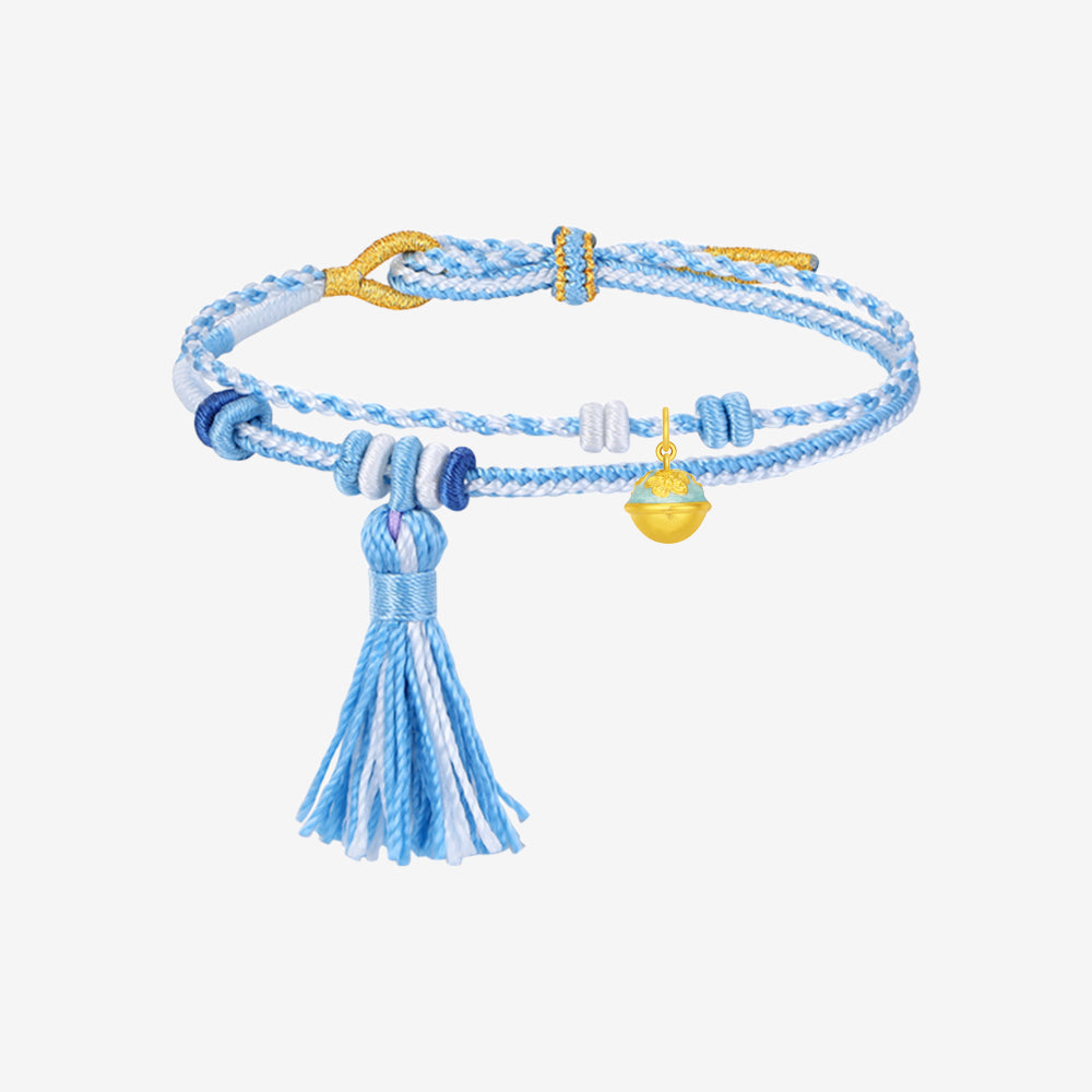Gold bell charm with blue-green enamel on the upper half, raised golden almond blossoms and a hanging loop