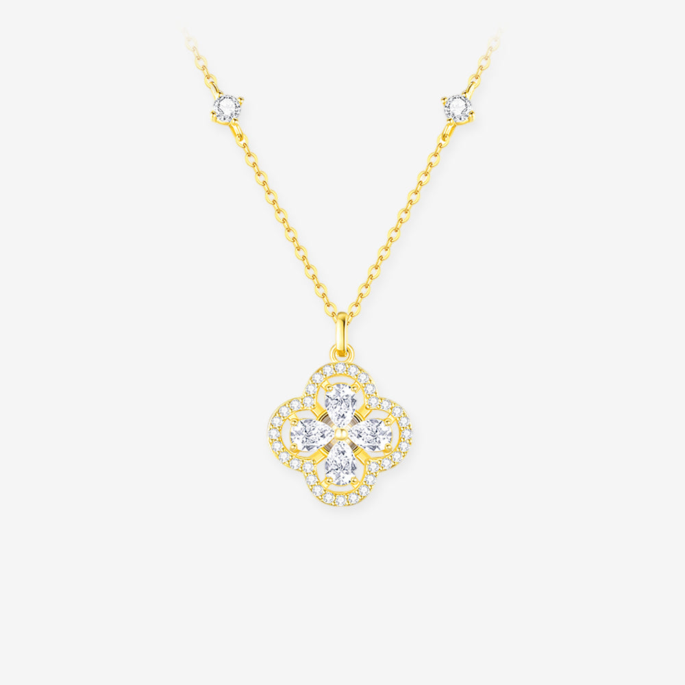 Gold-tone clover necklace with four pear-cut cubic zirconia, a sparkling halo and a station chain