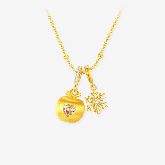ChowTaiSeng gold plated silver snowflake apple necklace, matte gold apple pendant with champagne heart cubic zirconia and snowflake charm on beaded gold chain, white background