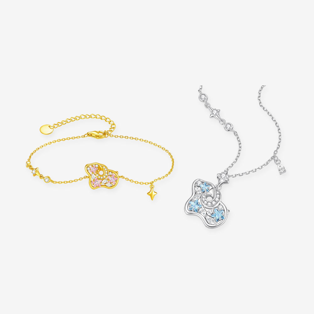 Pink cubic zirconia sheep bracelet in gold tone and blue cubic zirconia sheep necklace in silver tone on white