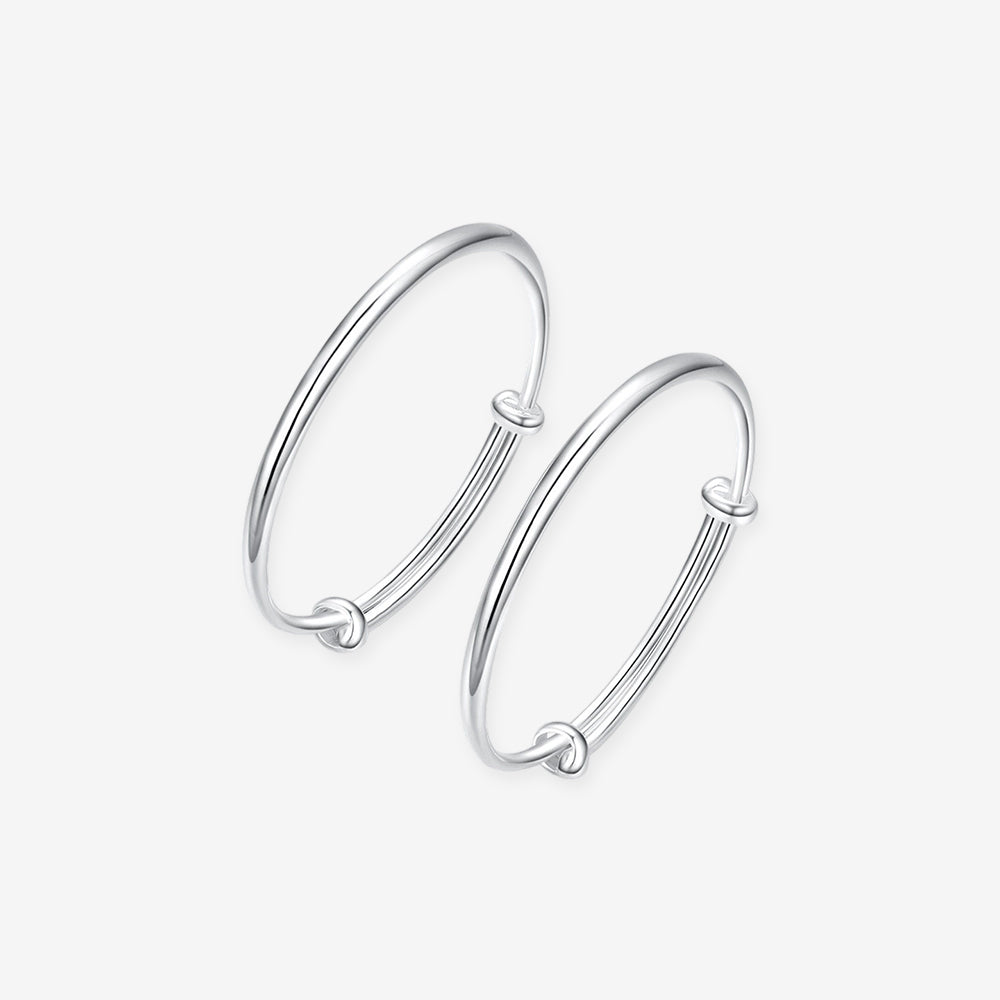 ChowTaiSeng 990 pure silver polished newborn baby bangles on white background — pair of smooth adjustable wire bangles with sliding knot closure, mirror-polished finish, SKU S0ZC0175