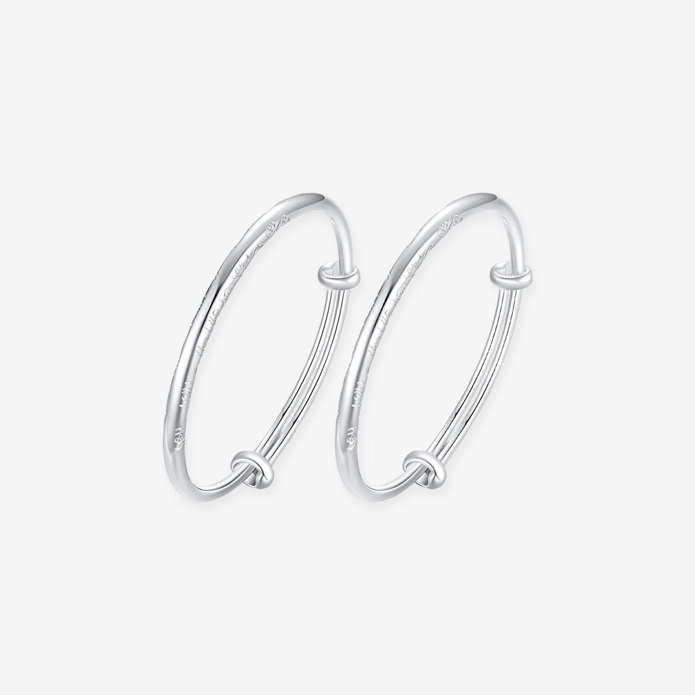 ChowTaiSeng 990 pure silver auspicious cloud baby bangles on white background — pair of adjustable sliding-knot bangles with delicate auspicious cloud (祥云) engravings along the band, smooth rounded profile, SKU S0ZC0200