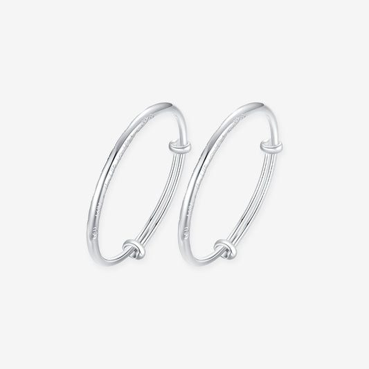ChowTaiSeng 990 pure silver auspicious cloud baby bangles on white background — pair of adjustable sliding-knot bangles with delicate auspicious cloud (祥云) engravings along the band, smooth rounded profile, SKU S0ZC0200