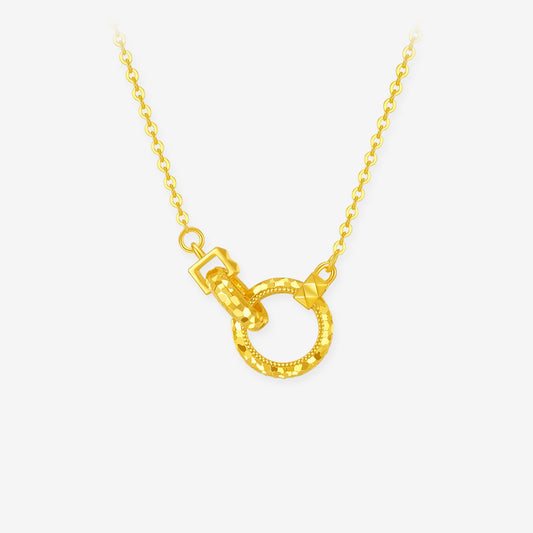 Gold-plated silver necklace with two interlocking faceted rings on a delicate chain against white